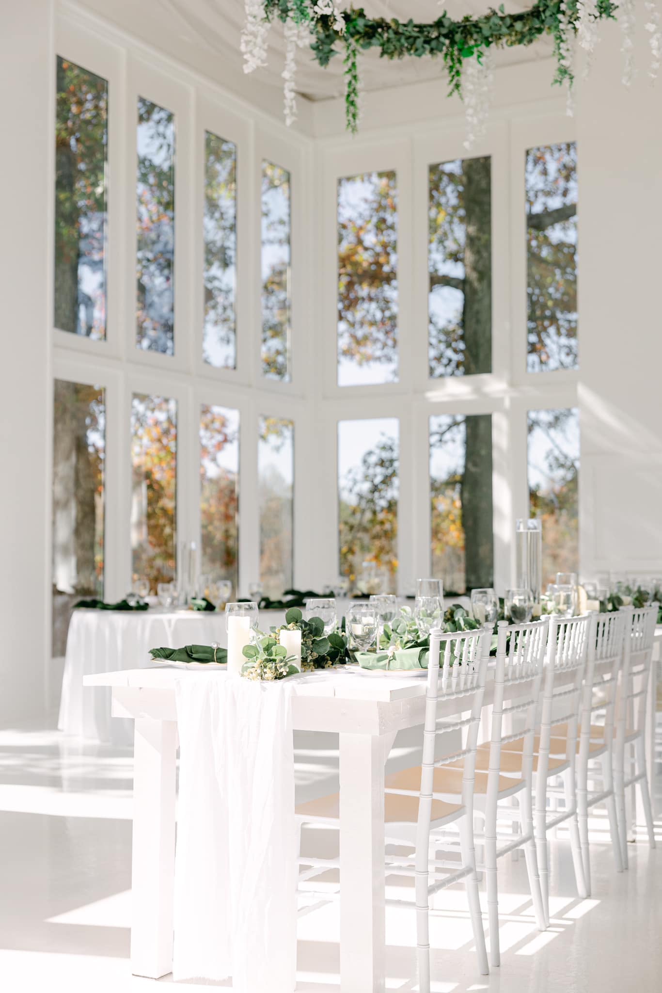 white tables and chairs set up in venue.