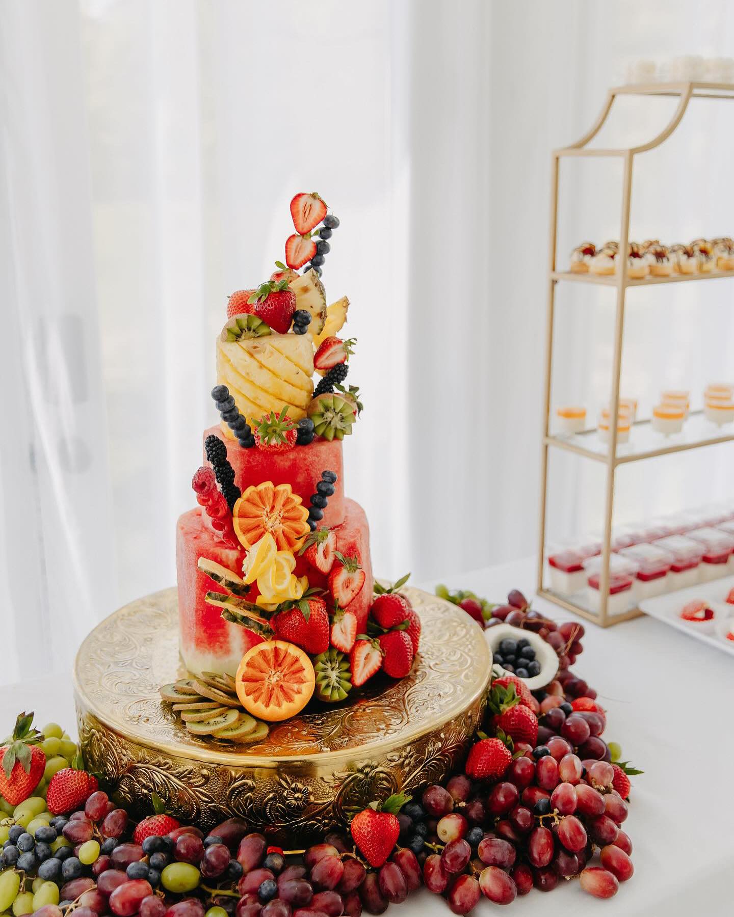 fruit cake made out of watermelon, pineapple, strawberries, and blueberries
