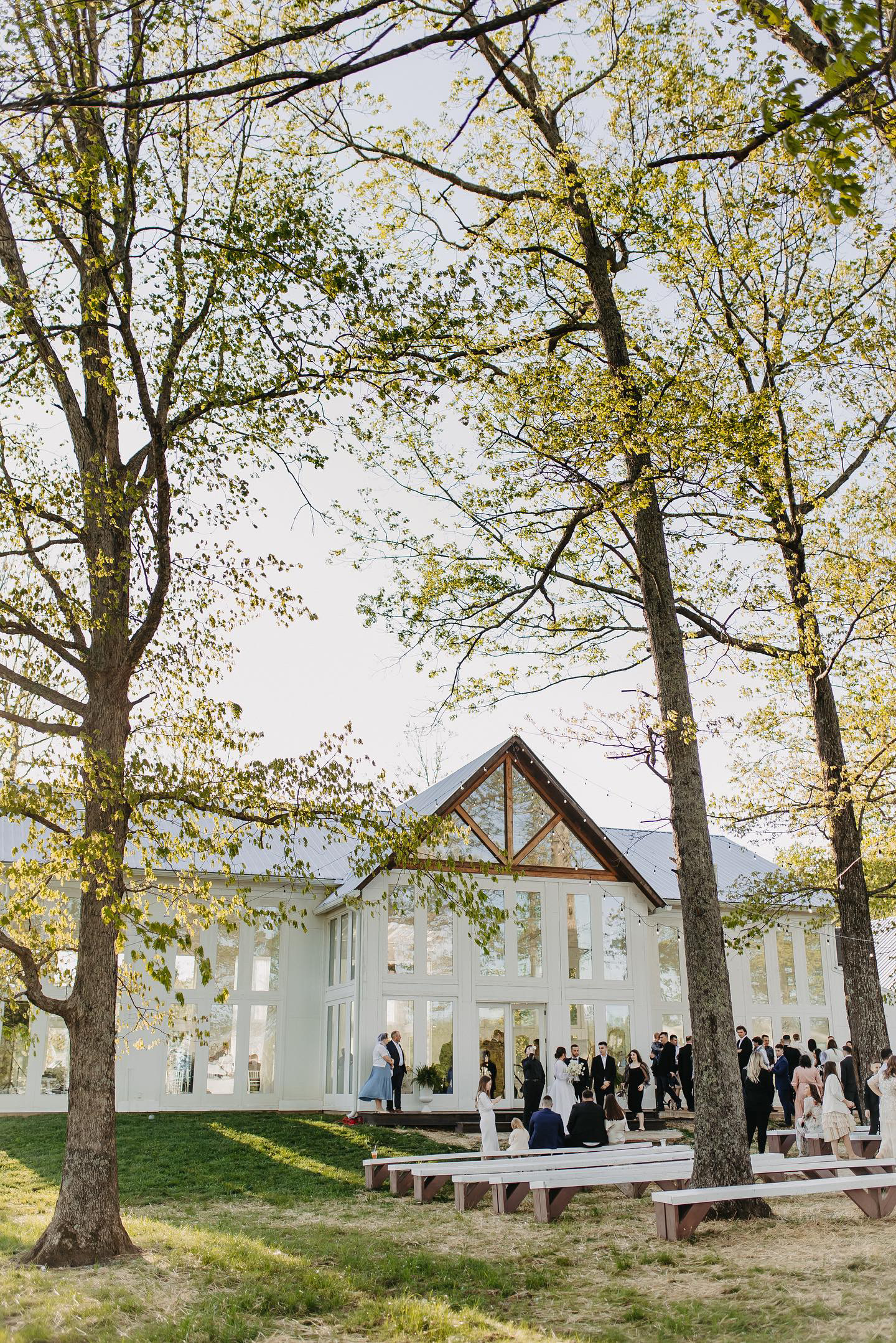 front of venue with wedding party and guests.