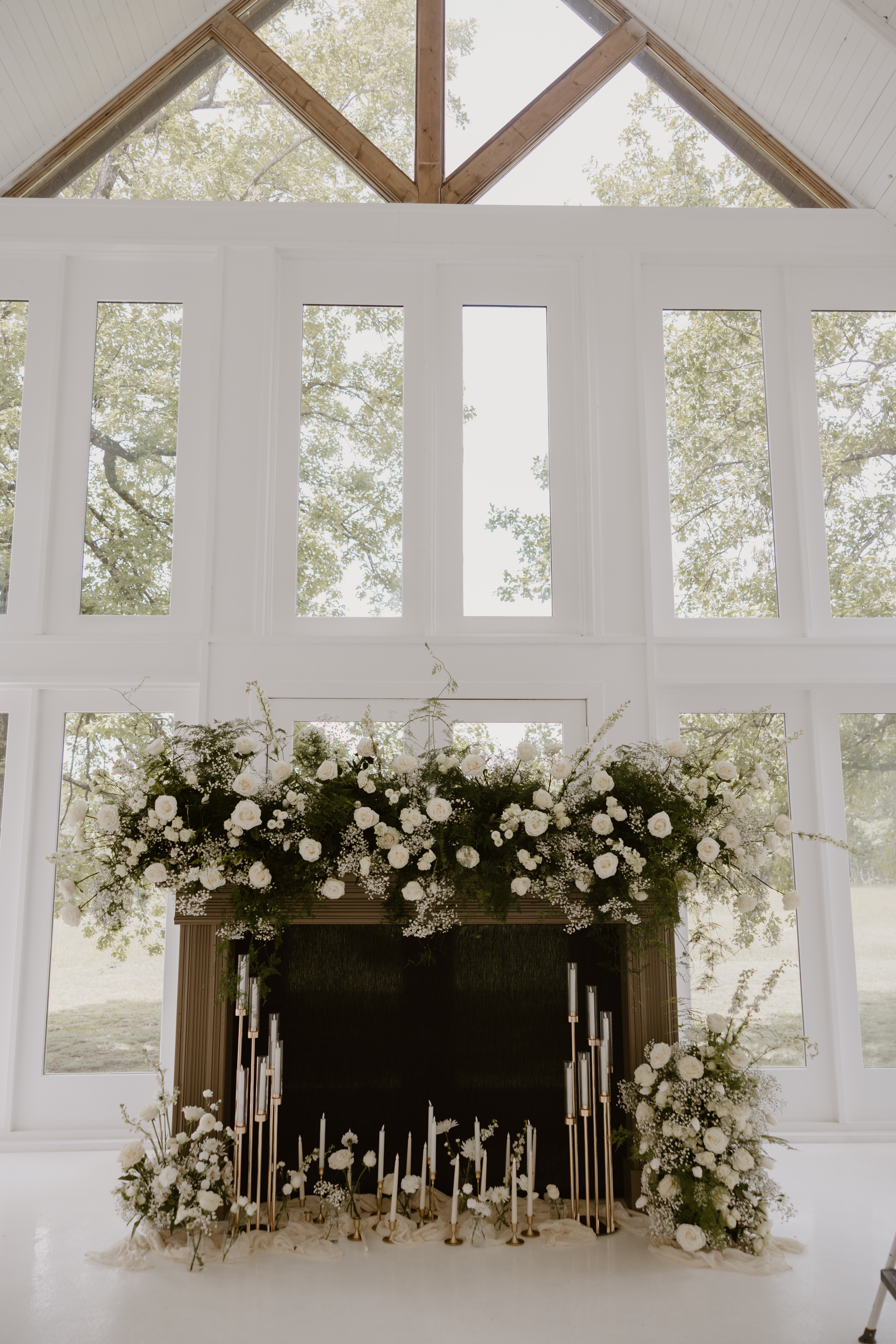 Fireplace with elegant florals and candlesticks - photo by Allie Krauser Digitals