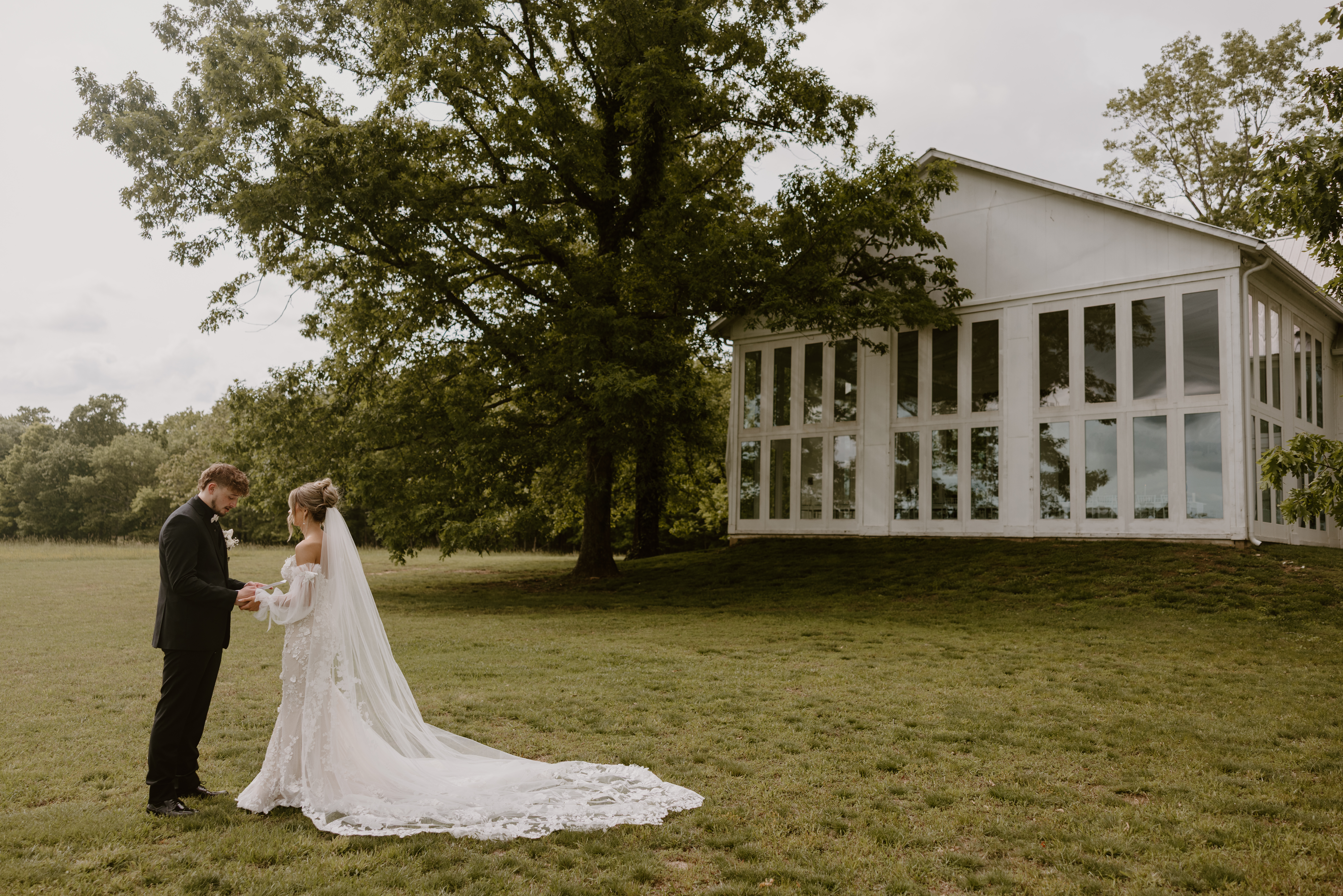 Bride and groom holding hands in front of venue
