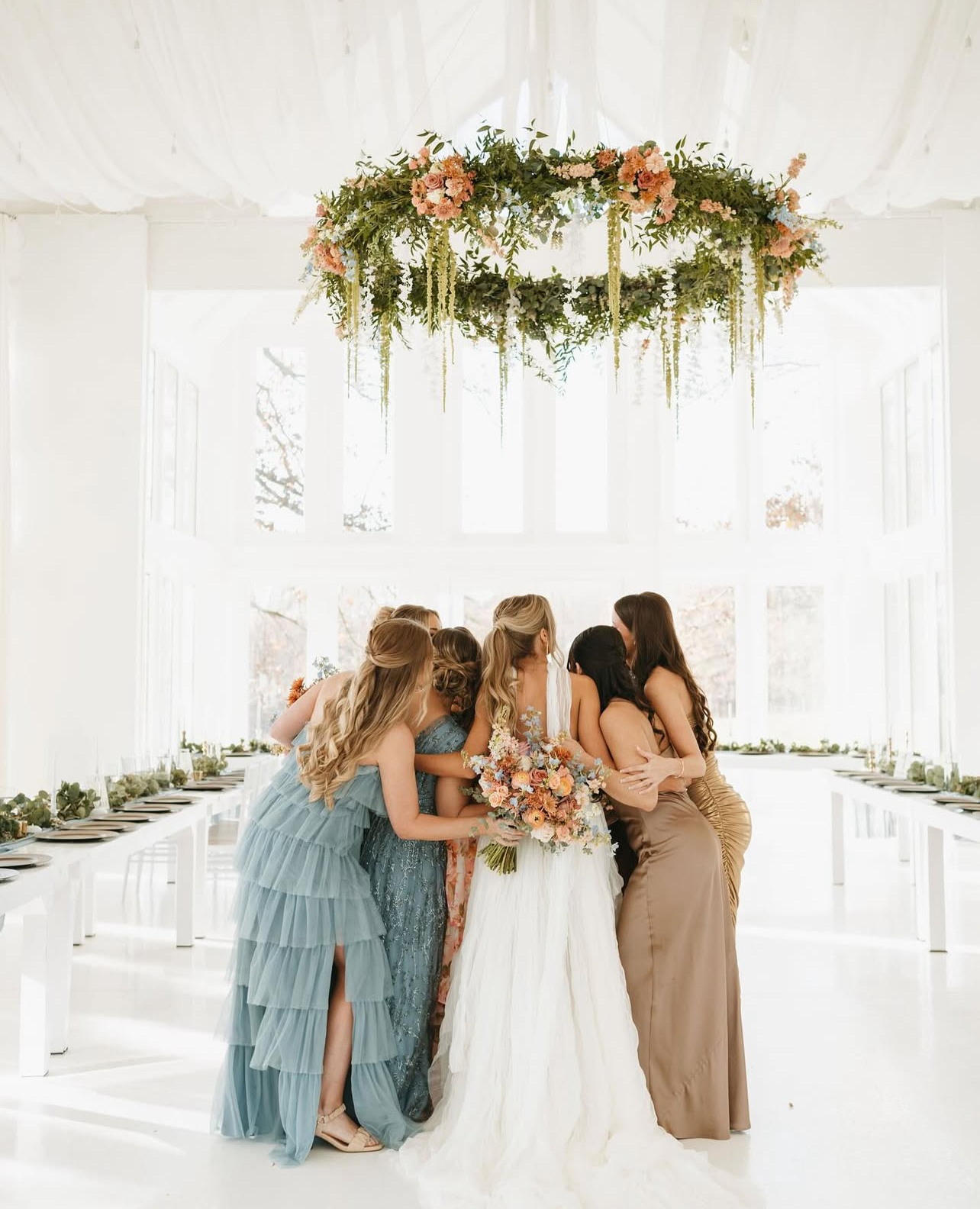 Bridesmaids hugging bride